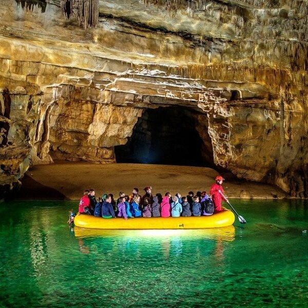 View inside Krizna Jama with underground lake and boat