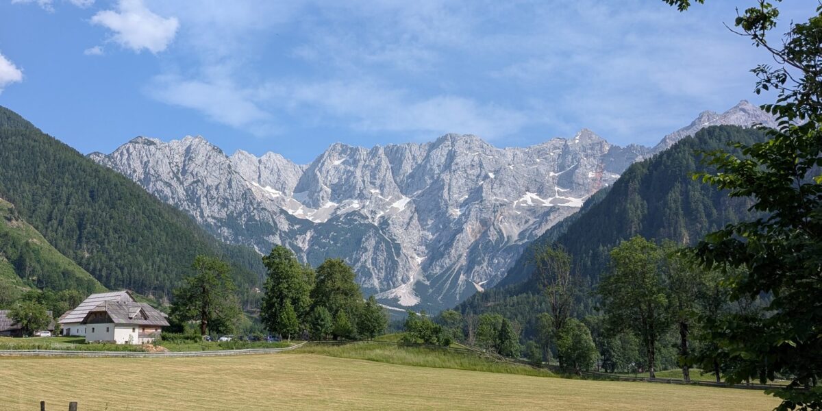 Slovenian landscape with forest, mountains, and a river – holiday travel tip