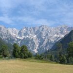 Slovenian landscape with forest, mountains, and a river – holiday travel tip