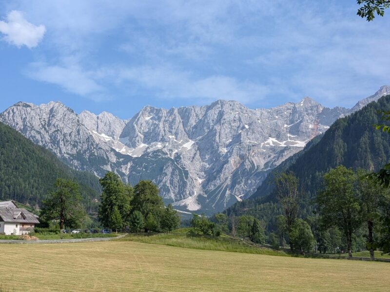 Slovenian landscape with forest, mountains, and a river – holiday travel tip