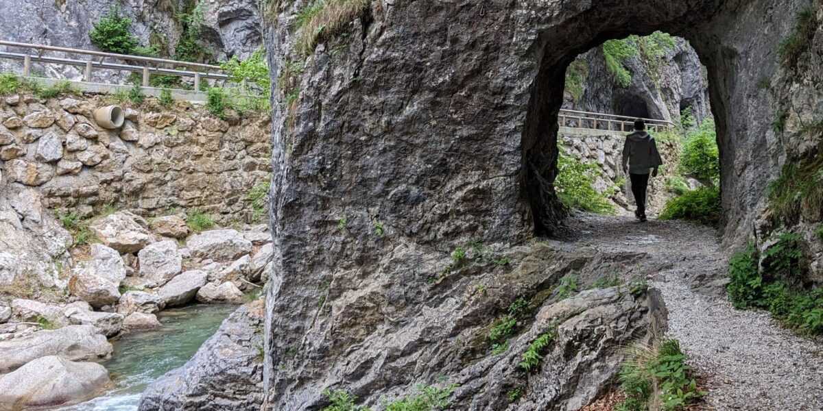 Clear river running through the Dovzan Gorge in Slovenia, surrounded by rocks and greenery