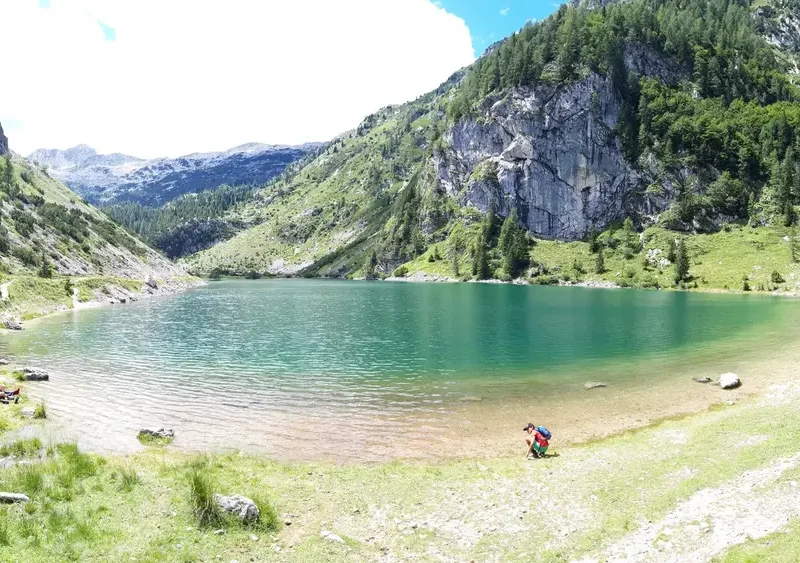 View of Lake Krsnko, a mountain lake surrounded by peaks, with clear water and rocky shore