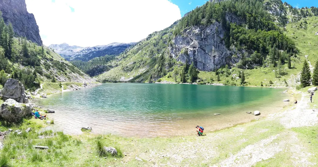 View of Lake Krsnko, a mountain lake surrounded by peaks, with clear water and rocky shore
