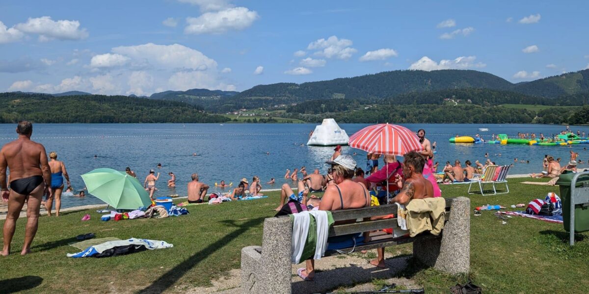 View of Lake Velenje with beach and mountains in Slovenia