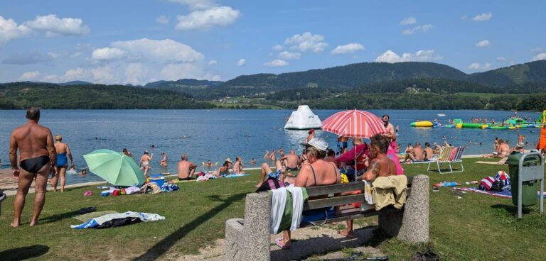 View of Lake Velenje with beach and mountains in Slovenia